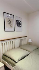 a bedroom with two beds and two pictures on the wall at Goslar FeWo Kultur & Naturgenuss in Goslar +14 photos