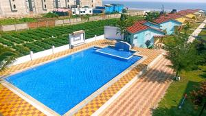 Una vista aérea de una piscina con el océano. en Star Inn Beachfront Resort, en Mandarmani