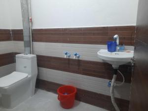 a bathroom with a toilet and a sink at Hotel O Sangam in Sohna