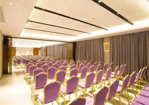 a conference room with purple chairs in a row at Borrman Hotel Nanning Railway Station in Nanning