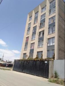 a tall building with a fence in front of it at Fitbull Homes Rm 210 in Nairobi +1 photo