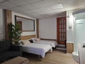 a room with two beds and a couch and a mirror at Real 43 Buen camino in Neda +62 photos