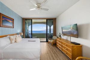 a bedroom with a bed and a dresser with a window at Lahaina Shores PH1 · LS PH1 Oceanfront Penthouse Condo w Panoram in Lahaina +55 photos