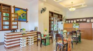 a dining room with a table and some chairs at Kim's Villa Hoi An in Hoi An