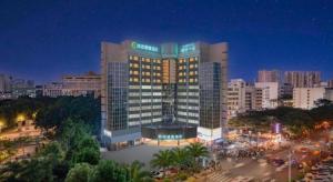 a large hotel building in a city at night at City Comfort Inn Nanning Guangxi University in Nanning