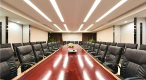 a conference room with a long table and leather chairs at PARK INN KUNMING AIRPORT in Kunming