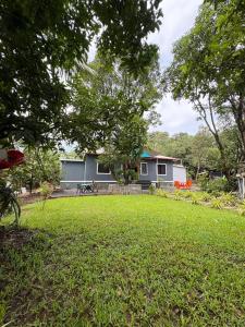 a yard with a house in the background at Juee's Holiday Homes in Alibaug