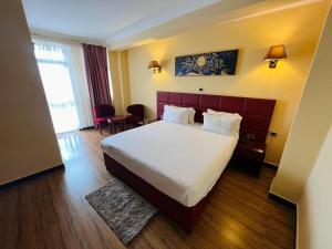 a hotel room with a bed and a table at Moonlight Addis Hotel in Addis Ababa