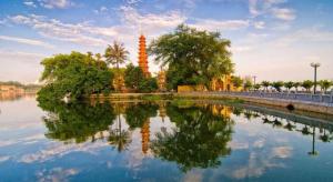 a large body of water with trees and a tower at Binh Anh Hotel Hanoi in Hanoi