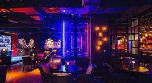 a restaurant with tables and chairs and purple lights at NH Shijiazhuang Financial Center in Shijiazhuang