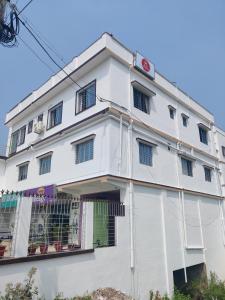 a white building with windows at Hotel Seven Heaven in mayapur
