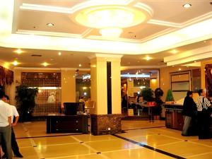 a lobby with people walking around in a building at Out Sky Hotel in Huizhou