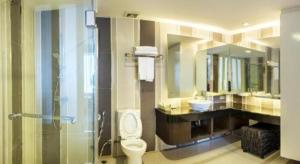 a bathroom with a toilet and a sink and a shower at Thamrongin Hotel in Bangkok +85 photos