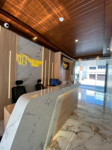 a hotel room with a bed with a marble counter at The Bali Hotel in Sumedang Utara