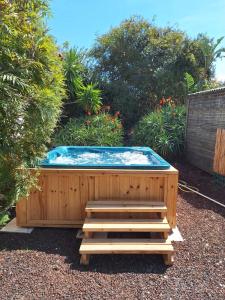 a hot tub in a garden with a wooden deck at Sleeps 12 Family Villa By The Sea W Jacuzzi & Pool in Jisr ez Zarqā