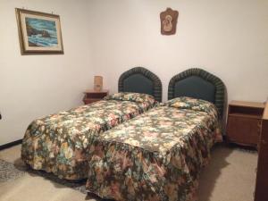 サン・マルチェッロ・ピストイエーゼにあるResidenza Cecchiniのベッドルーム1室(ベッド2台付)