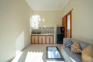 a living room with a couch and a table at Gusti family guest house in Tegalalang +15 photos