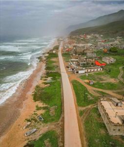 an aerial view of a beach next to the ocean at محمية حوف 
