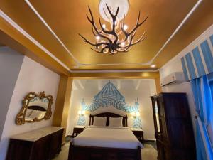 a bedroom with a bed with a deer head on the ceiling at Medieval Forts & palaces in Pachār +26 photos