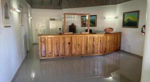 a wooden counter in a room with a mirror at Gold Nugget Hotel in Negril +81 photos