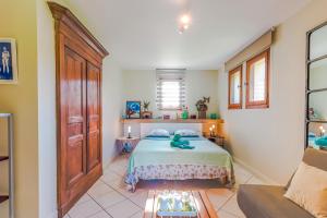 a bedroom with a bed with a teddy bear on it at Gite Rive Gauche - Bergerac in Bergerac