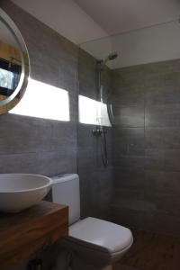 a bathroom with a sink and a toilet and a mirror at Ośrodek Delfin in Ślesin
