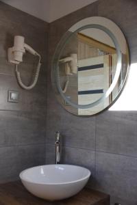 a bathroom with a white sink and a mirror at Ośrodek Delfin in Ślesin