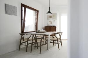 a dining room with a table and chairs at Villa Orso Blue II in Ioulis