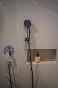 a shower head in the corner of a bathroom at Gusti family guest house in Tegalalang