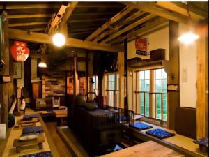a room with tables and windows in a building at Auberge Kitano Dandan in Abashiri