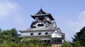 a large white building with a clock tower at Inuyamakan in Inuyama