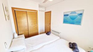 a bedroom with a bed and a wooden door at Spacious Ground Floor Apartment, Free WiFi, Patio, AC in Sucina +7 photos