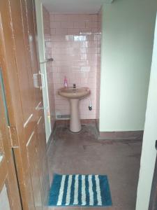 a small bathroom with a sink and a toilet at Roopa Studio in Mysore