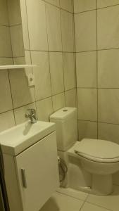 a white bathroom with a toilet and a sink at Ephesus Selcuk Castle View Suites in Selçuk