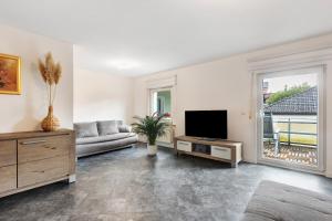 a living room with a couch and a television at Fewo Schneider Bad Wildungen in Bad Wildungen