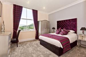 a bedroom with a large bed and a window at Diamond Lodge Boutique Adults Only Guest House in Ambleside