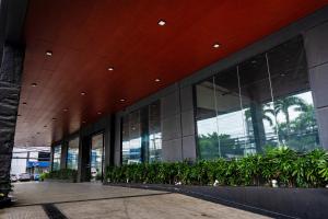 a large building with a lot of windows and plants at Green Sun Hotel in Manila