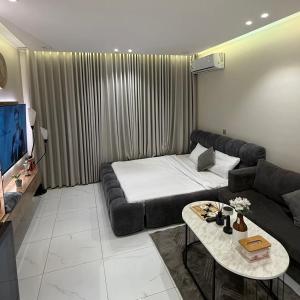 a living room with a couch and a table at لوله ستديو in Buraydah +20 photos