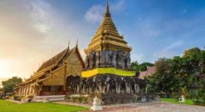 a building with a pagoda in front of it at Mon Muang Hotel in Chiang Mai