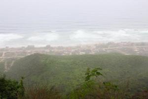 a view of a green field with the ocean at محمية حوف 