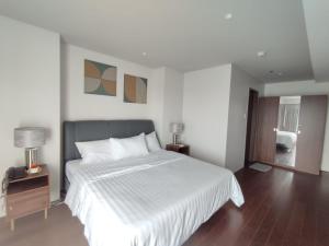 a bedroom with a large bed with a white bedspread at Tambuli Seaside Resort 16G - Lapu Lapu in Maribago +15 photos