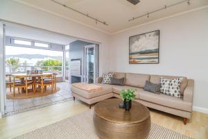 a living room with a couch and a table at The Anchor at Thesen Island in Knysna