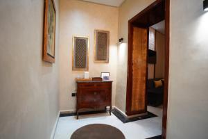 a hallway with a wooden dresser in a room at Le 146 - Art of Living in Rabat