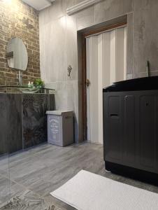 a bathroom with a sink and a mirror and a door at La Mouna 4 in Bultfontein in Bultfontein