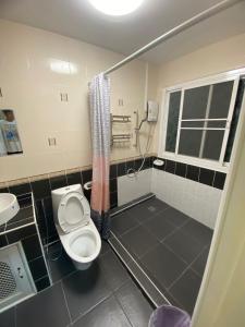 a bathroom with a toilet and a shower at กัญญ่า เพลส KANYA in Maha Sarakham