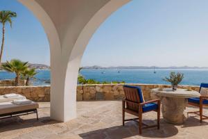a patio with a table and chairs and the ocean at One&Only Palmilla in San José del Cabo +254 photos