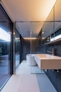 a bathroom with a large sink and a tub at Miharaya in Onomichi +16 photos