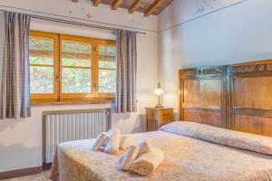 a bedroom with two beds and a window at Agriturismo Il poggiarello in Foiano della Chiana