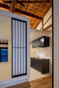 a kitchen with a large glass door leading into a room at Miharaya in Onomichi