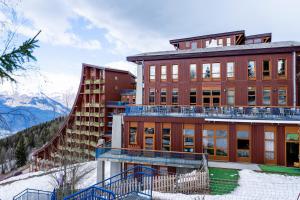 a building on top of a snow covered mountain at Villages Clubs du Soleil - ARC 1800 in Arc 1800